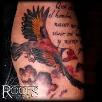 Flying bird tattoo